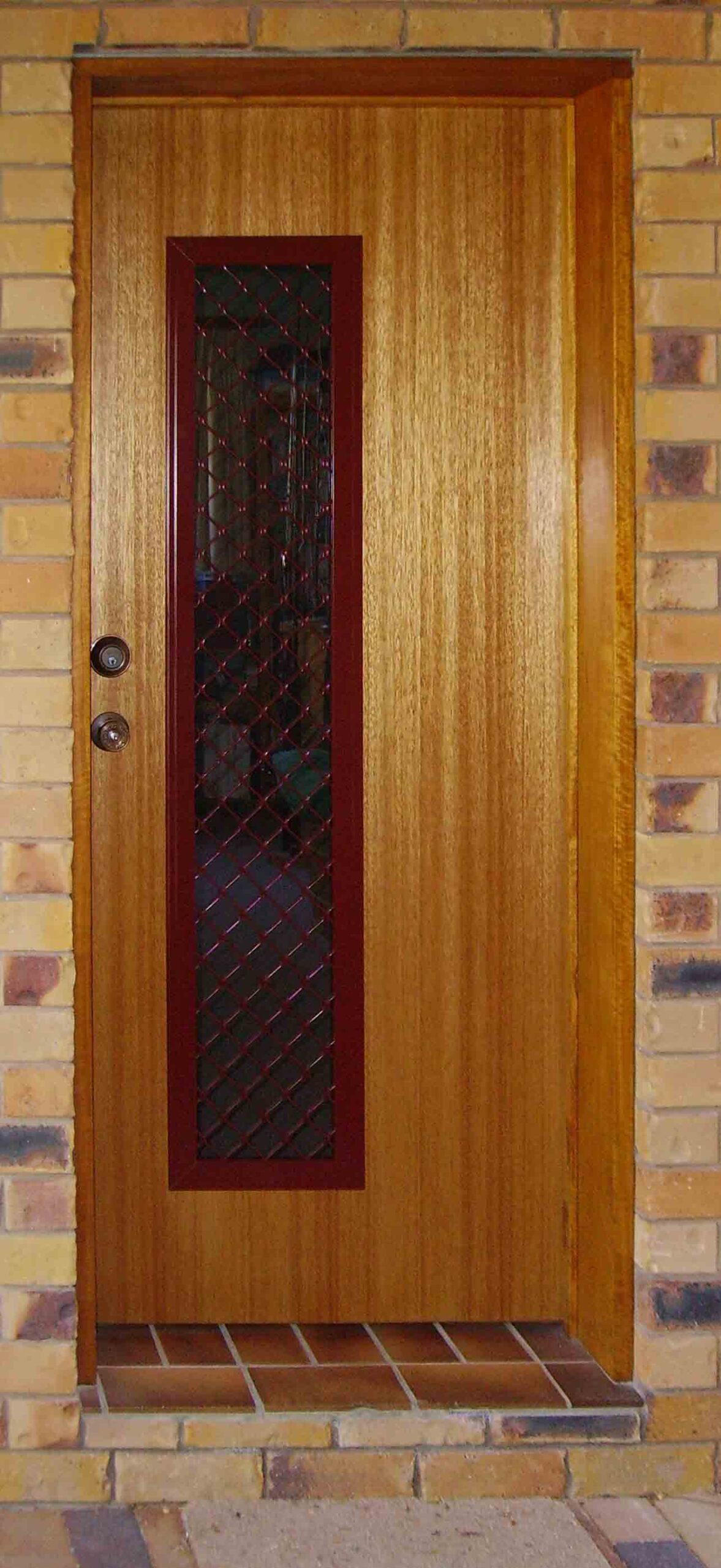CombiDoor with timber finish and small diamond alloy security grill powdercoated Manor Red